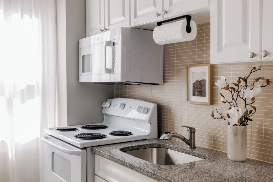 The One-Bedroom Queen Apartment | Private kitchen | Coffee/tea maker, fridge, microwave, cookware/dishes/utensils