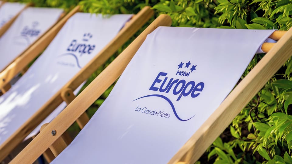 Seasonal outdoor pool, open 9:00 AM to 9:00 PM, pool umbrellas