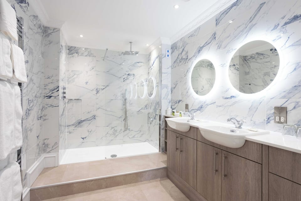 Suite | Bathroom | Designer toiletries, hair dryer, bathrobes, towels