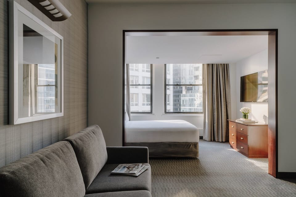Premium bedding, desk, laptop workspace, blackout drapes