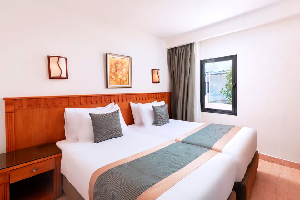 Deluxe Family Room | Minibar, in-room safe, blackout drapes, soundproofing