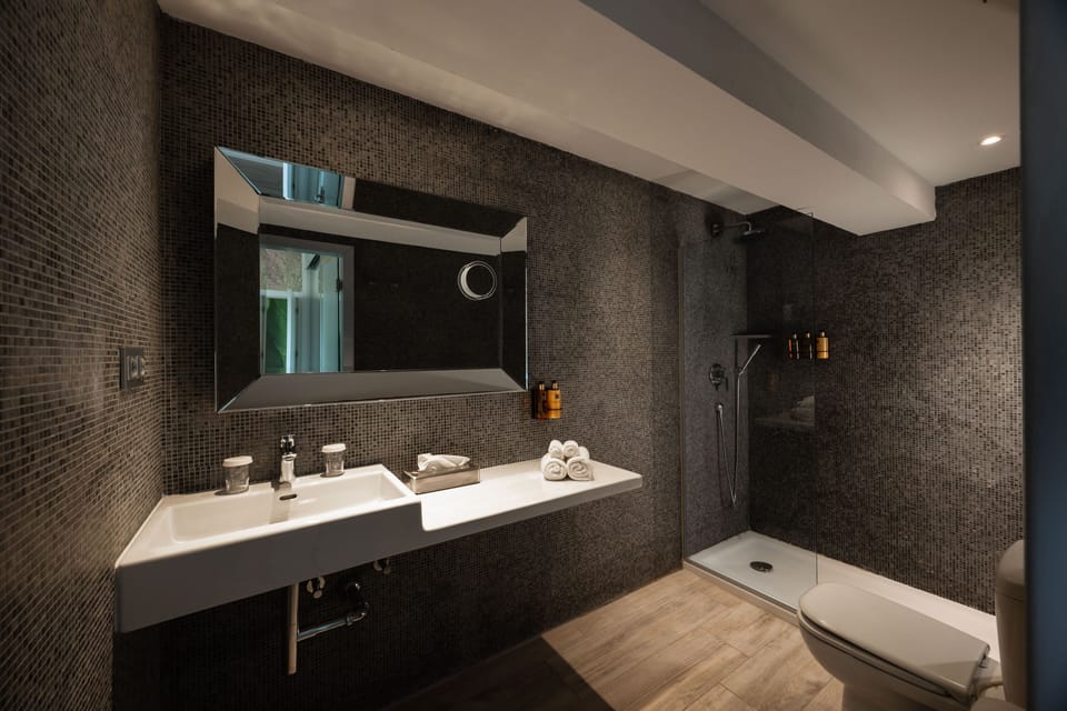 Shower, designer toiletries, hair dryer, bathrobes