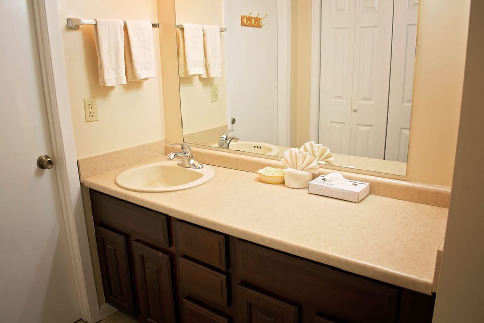 Condo, 2 Bedrooms (402) | Bathroom | Combined shower/tub, free toiletries, towels, soap