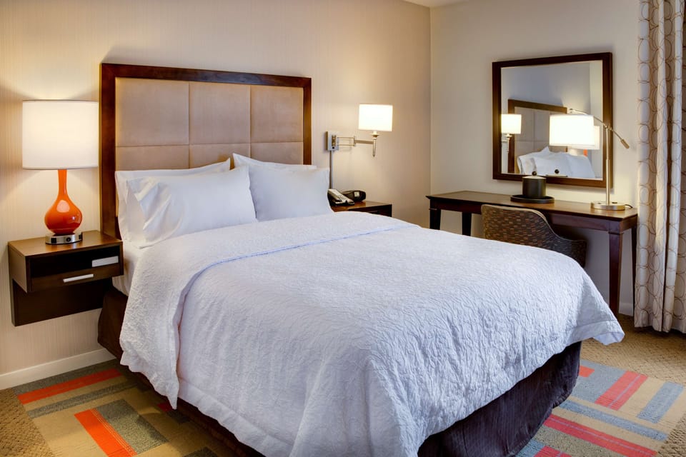 Premium bedding, desk, laptop workspace, iron/ironing board