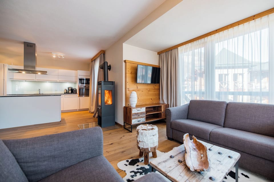 Four-Bedroom Apartment 4B | Living area | 40-inch TV with cable channels, heated floors