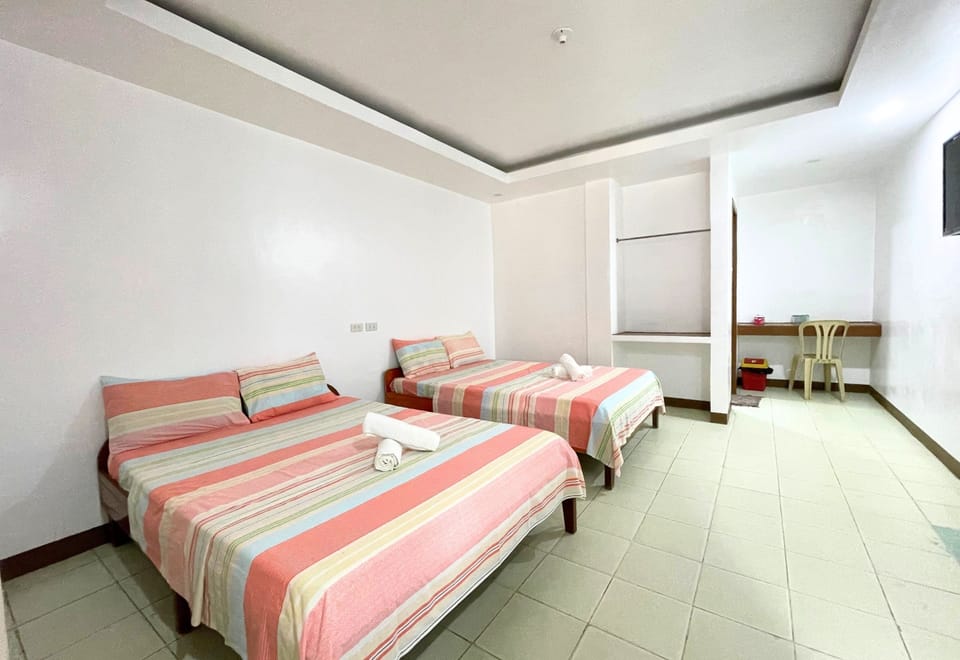 Deluxe Quadruple Room | Desk, bed sheets