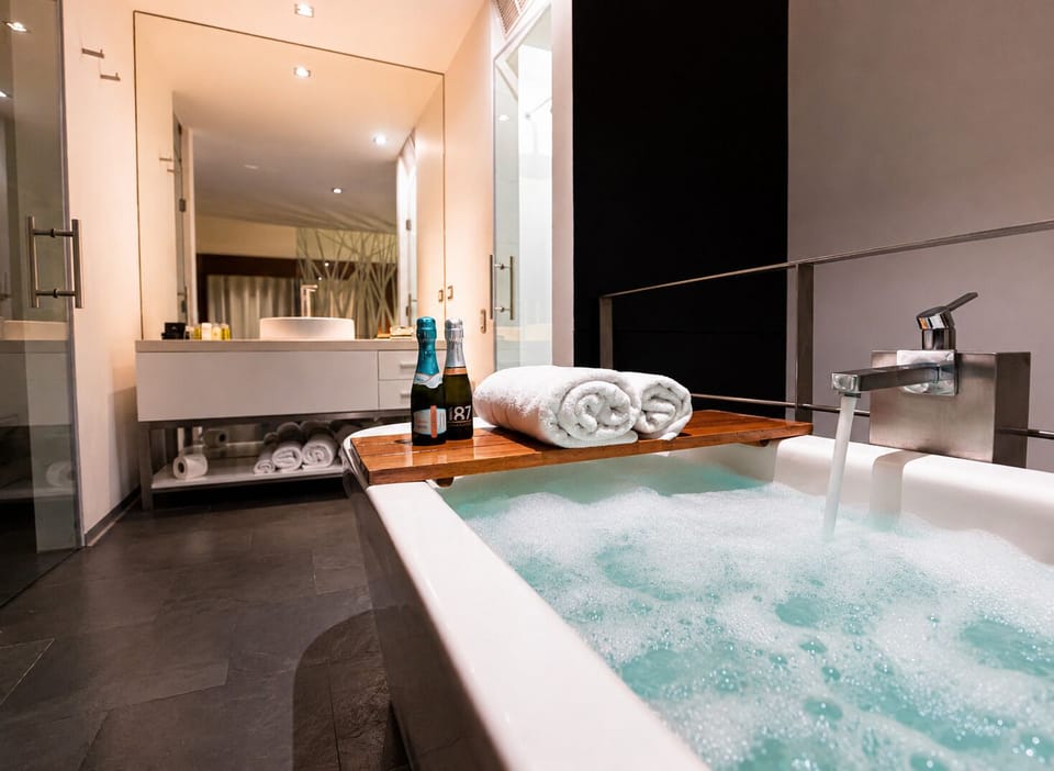 Deluxe Duplex, Tower | Bathroom | Combined shower/tub, jetted tub, rainfall showerhead, free toiletries