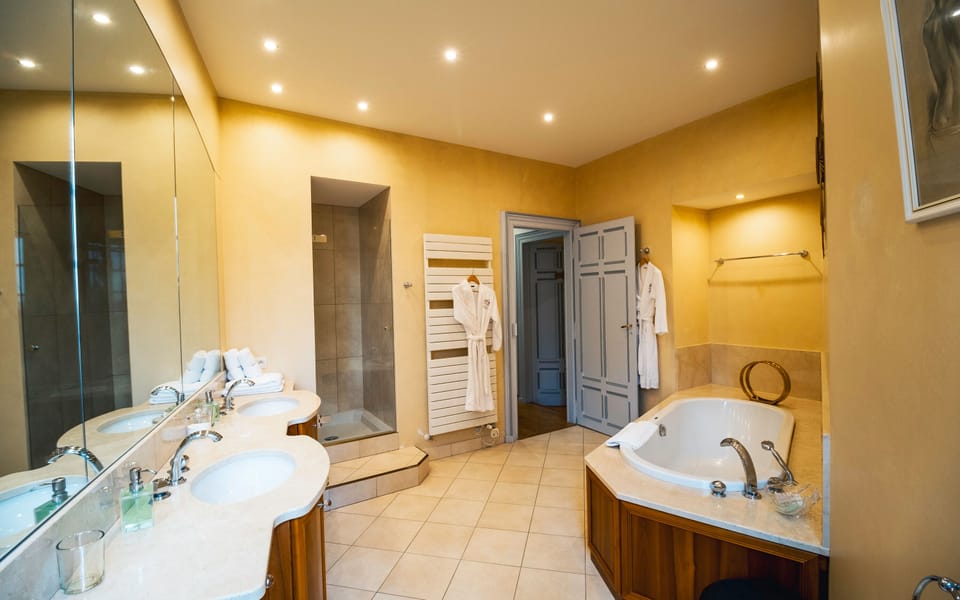 Separate tub and shower, bathrobes, slippers, towels