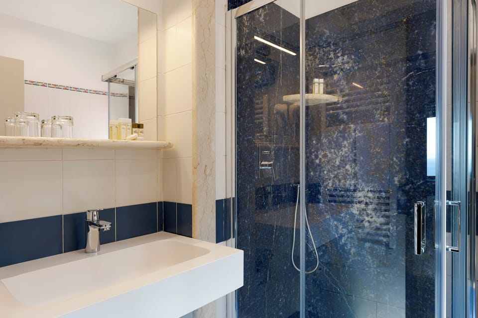 Shower, designer toiletries, hair dryer, towels