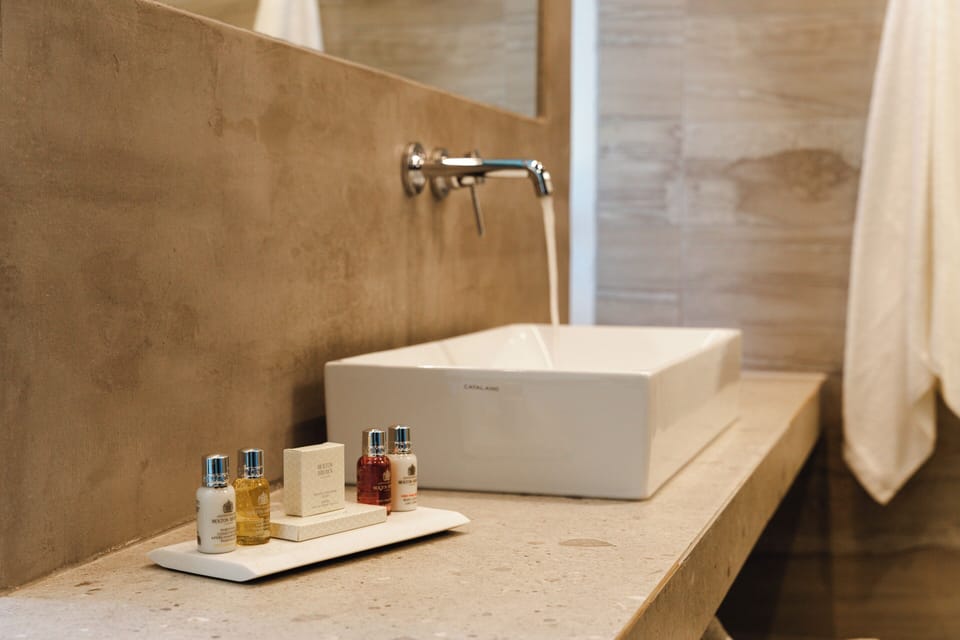 Designer toiletries, hair dryer, bathrobes, slippers