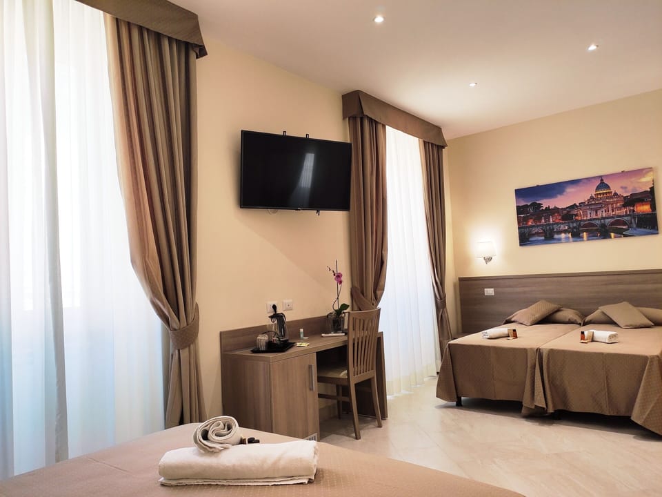 Family Quadruple Room | Minibar, in-room safe, individually decorated, individually furnished