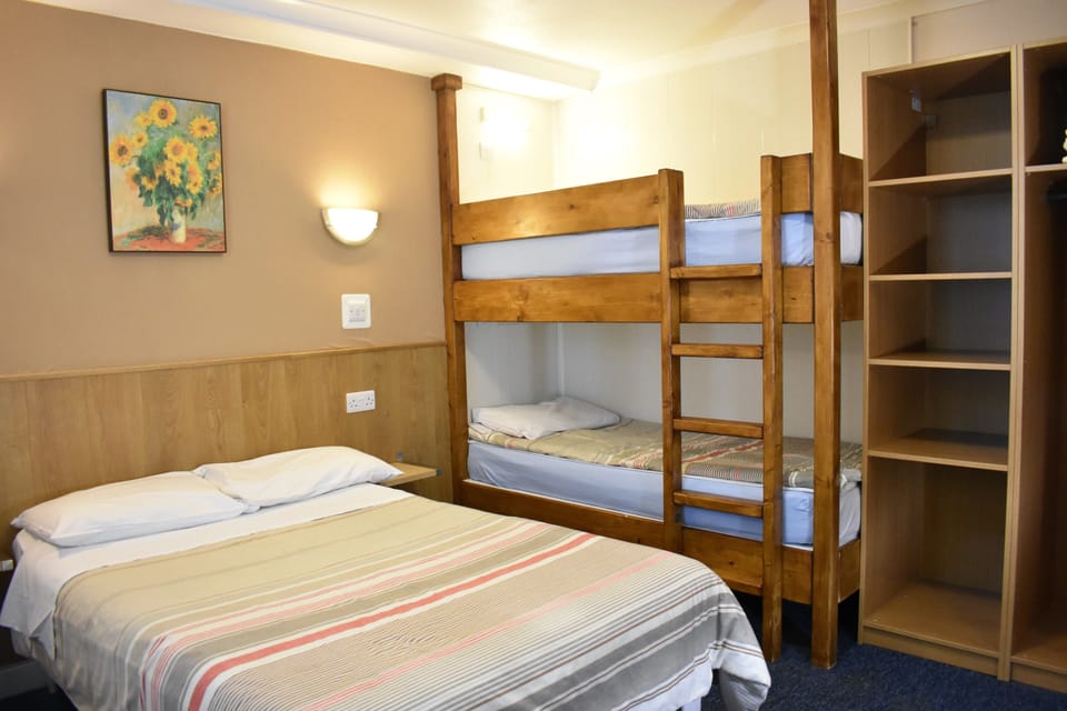 Family Quadruple Room, Multiple Beds, Ensuite | Down comforters, blackout drapes, iron/ironing board (on request)