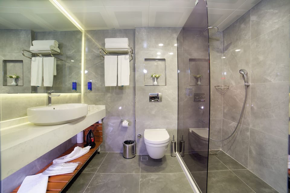 Shower, hair dryer, slippers, towels