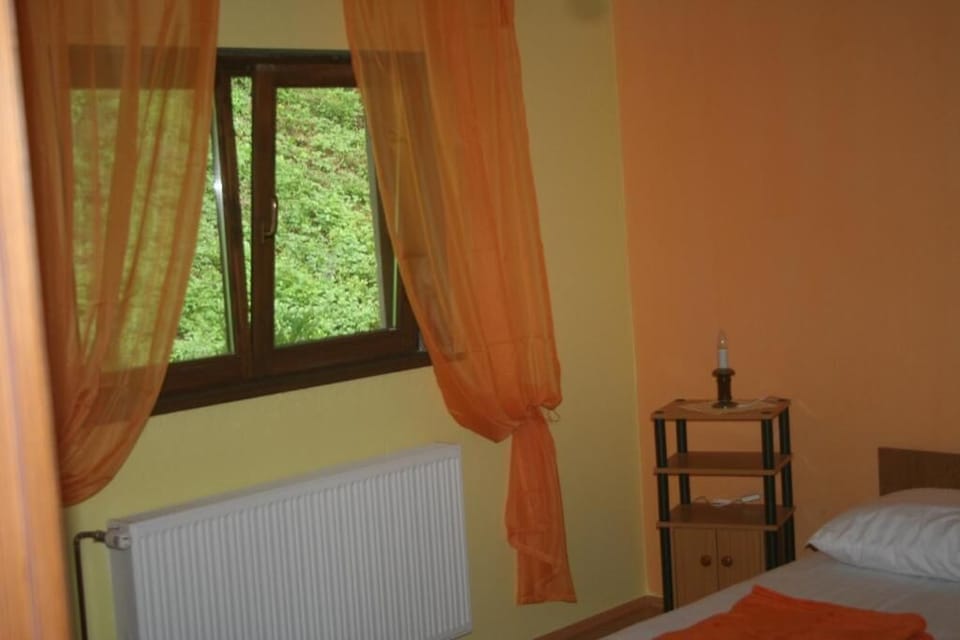 Desk, laptop workspace, iron/ironing board, bed sheets