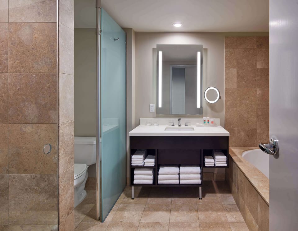 Jetted tub, rainfall showerhead, designer toiletries, hair dryer