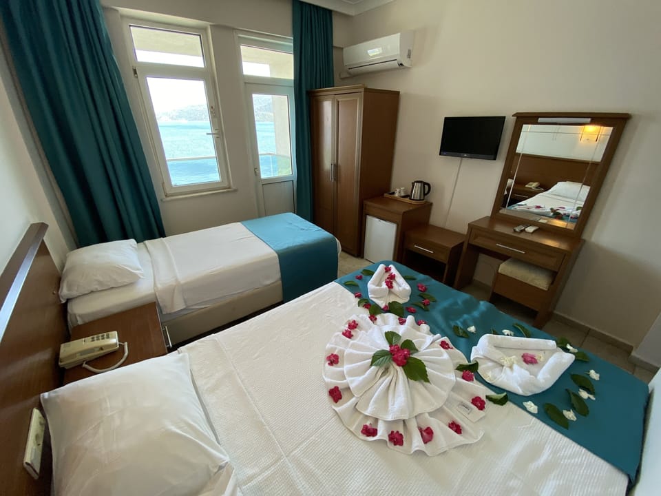 Standard Room, Sea View | Minibar, in-room safe, free WiFi, bed sheets