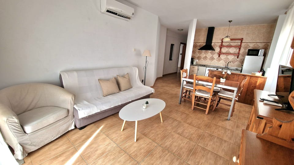 Standard Apartment, Partial Sea View | Living area | 32-inch Smart TV with cable channels, TV