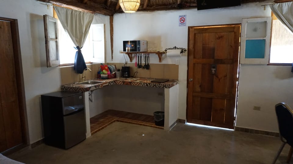 Coffee/tea maker, mini-fridge, microwave, cookware/dishes/utensils