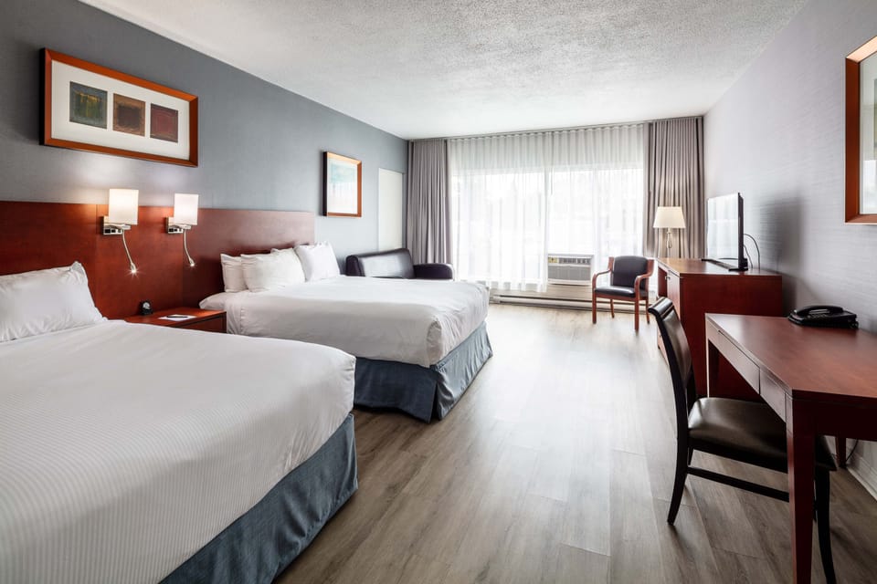 Deluxe Room, 2 Queen Beds, Non Smoking | Desk, laptop workspace, blackout drapes, iron/ironing board