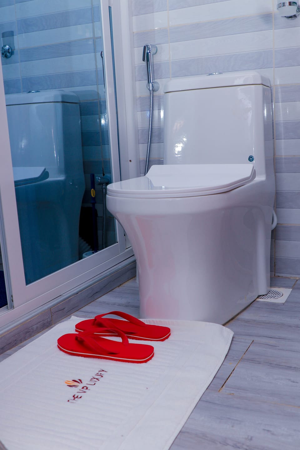 Shower, rainfall showerhead, slippers, towels