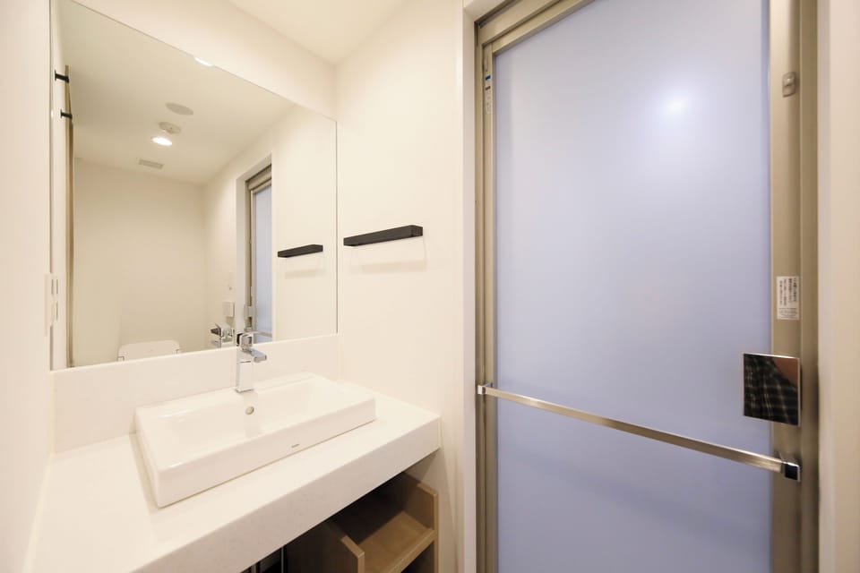 Eco-friendly toiletries, hair dryer, slippers, bidet