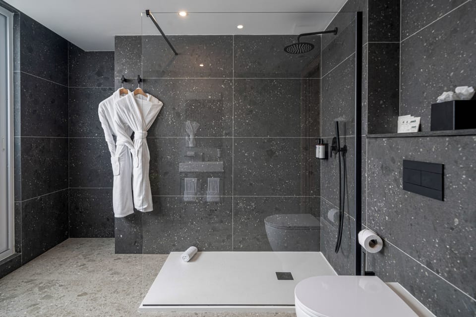 Superior Room, 1 King Bed | Bathroom | Shower, rainfall showerhead, towels, soap