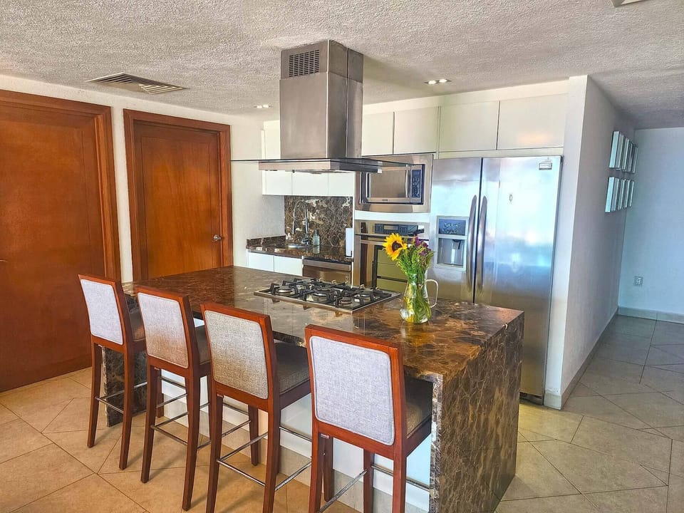 Deluxe Condo | Private kitchen | Full-size fridge, microwave, oven, blender