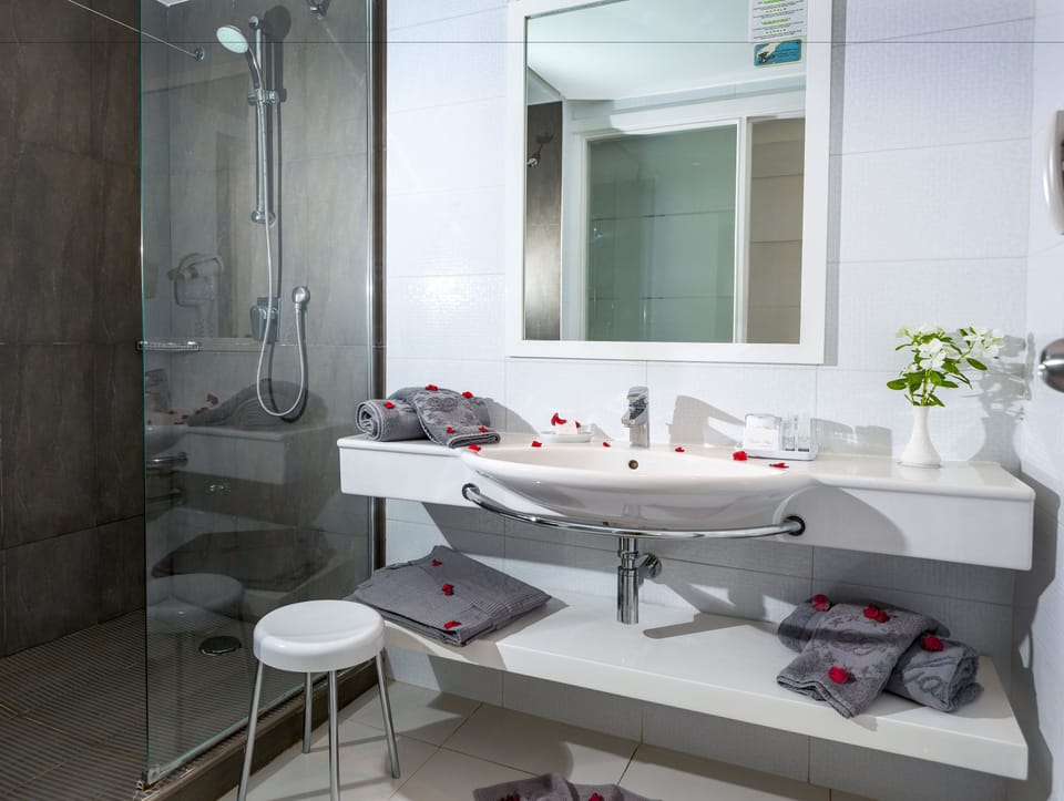 Shower, designer toiletries, hair dryer, bathrobes
