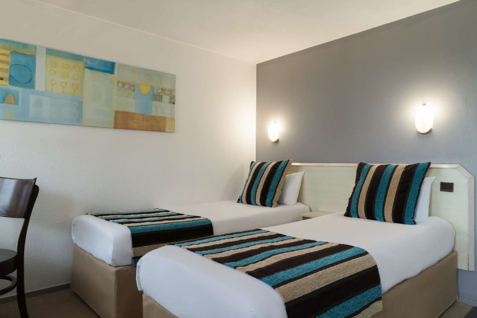 Premium bedding, desk, laptop workspace, blackout drapes
