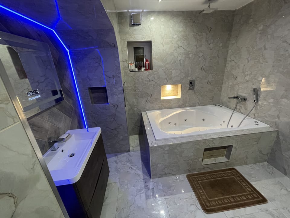 Apartment | Bathroom | Combined shower/tub, deep soaking tub, towels, toilet paper