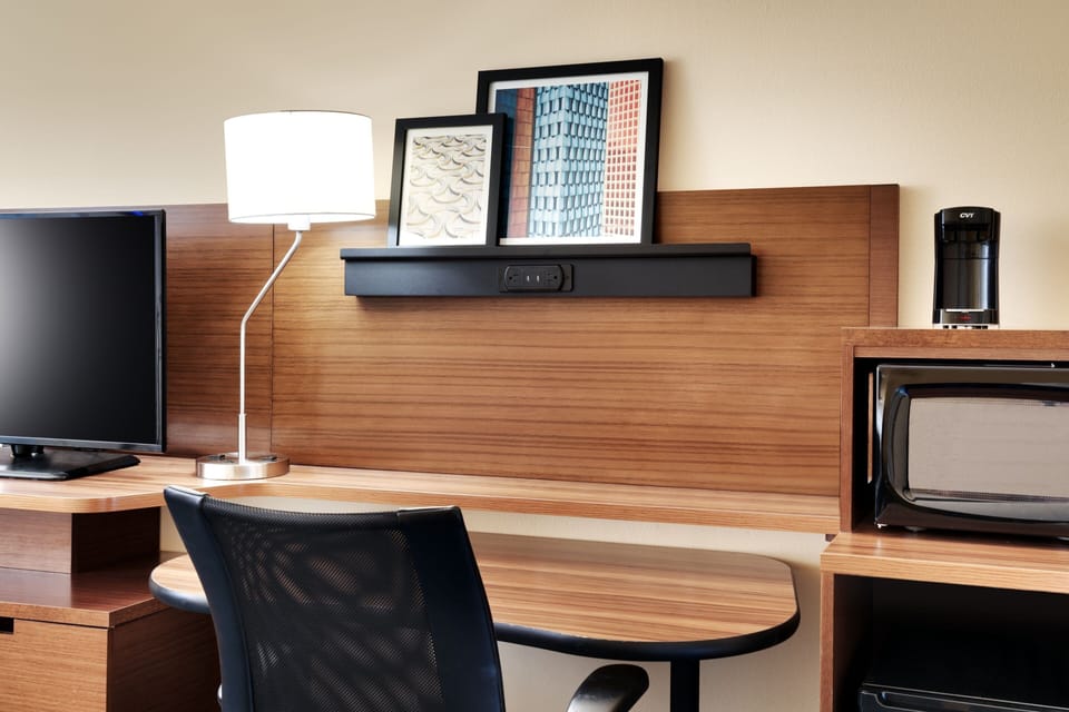 Desk, laptop workspace, iron/ironing board, free cribs/infant beds