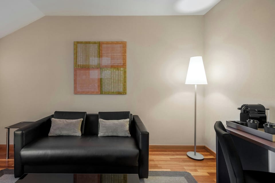 Junior Suite, 1 King Bed | Living room | Flat-screen TV