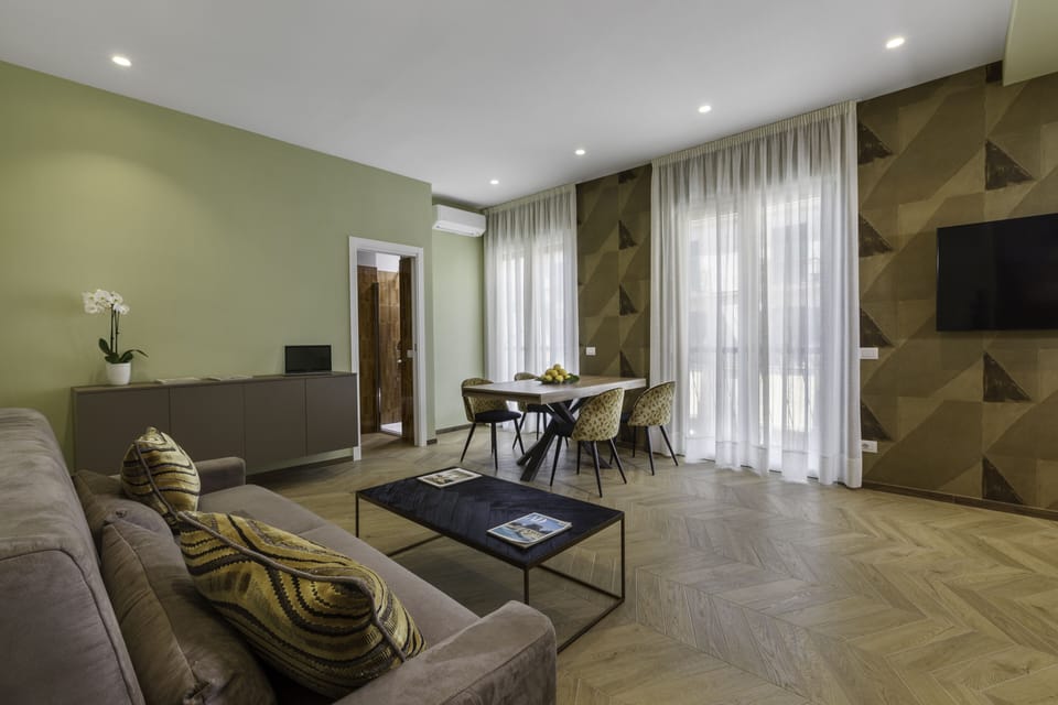 Family Quadruple Room | Living area | 45-inch Smart TV with satellite channels, TV