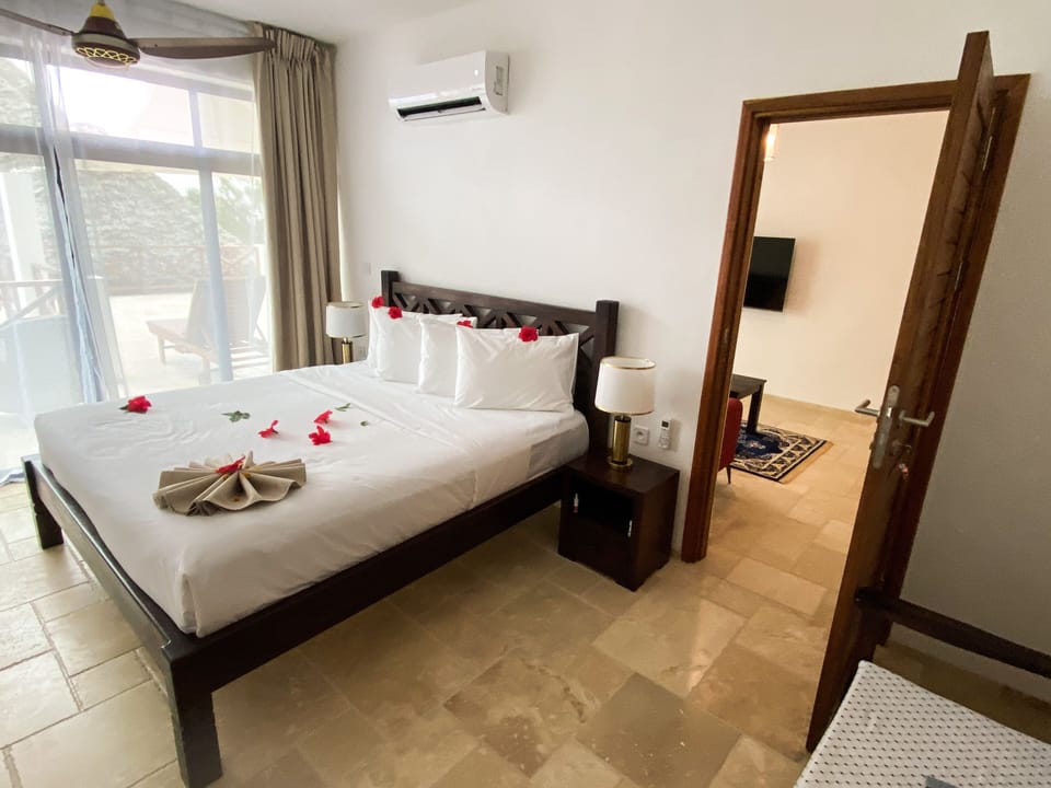 Deluxe Suite, Partial Ocean View | Egyptian cotton sheets, premium bedding, memory foam beds, minibar