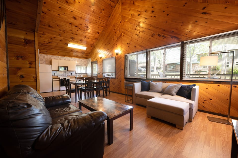 Deluxe Three-Bedroom Cottage | Living area | 32-inch TV with cable channels