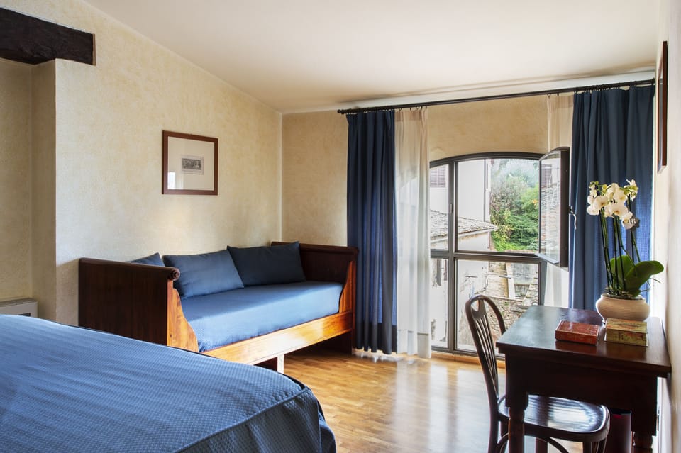 Triple Room | Minibar, in-room safe, desk, iron/ironing board