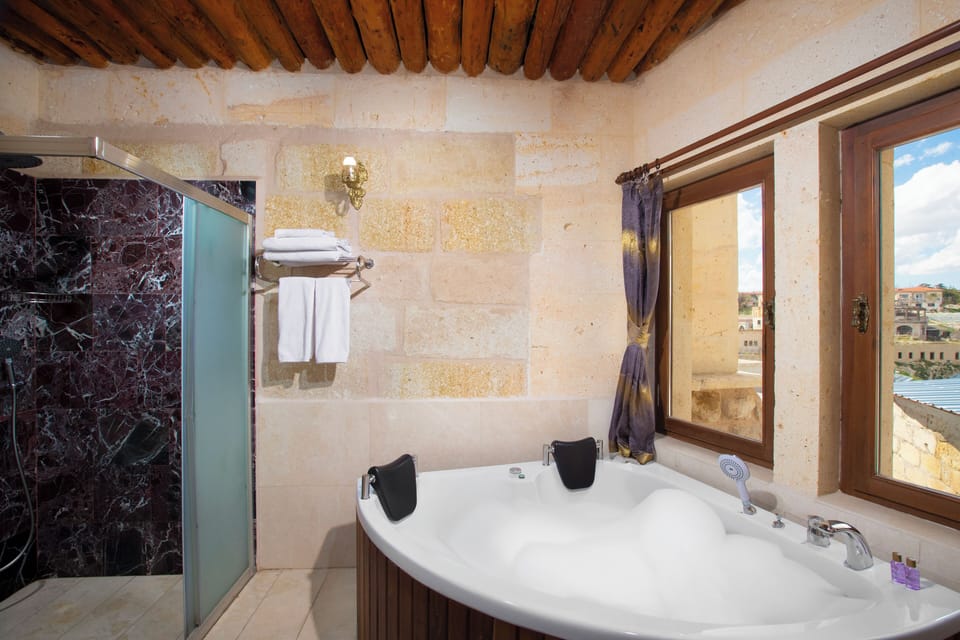 Superior Arch Suite | Bathroom | Shower, rainfall showerhead, designer toiletries, hair dryer