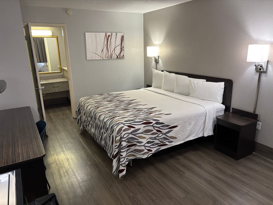 Premium bedding, desk, laptop workspace, blackout drapes
