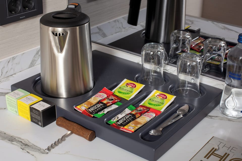Mini-fridge, coffee/tea maker, electric kettle, cleaning supplies