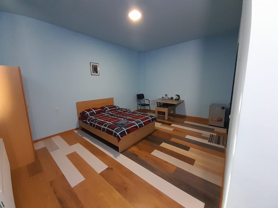 Economy Double Room | Down comforters, desk, laptop workspace, iron/ironing board