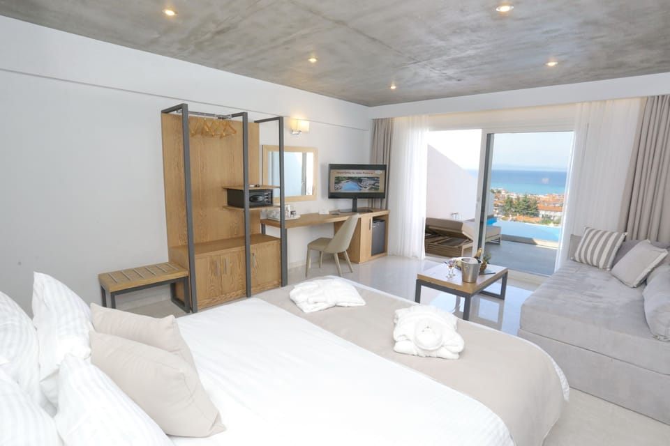 Deluxe Junior Suite (Panoramic Sea view with heated private pool) | Minibar, in-room safe, blackout drapes, iron/ironing board