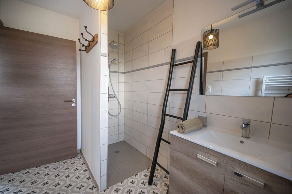 Comfort House | Bathroom | Shower, rainfall showerhead, hair dryer, toilet paper