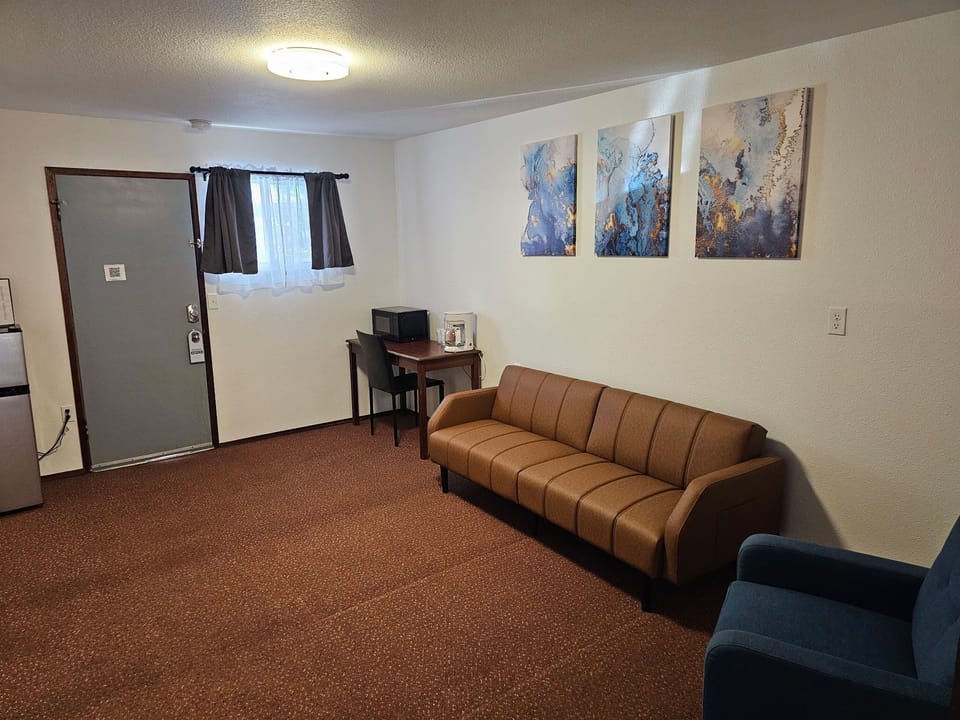 Suite, 1 King Bed with Sofa bed | Living area | 30-inch LCD TV with satellite channels, TV