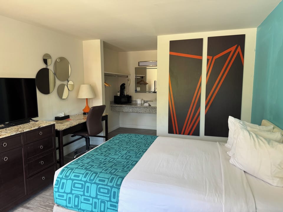 Desk, laptop workspace, blackout drapes, iron/ironing board