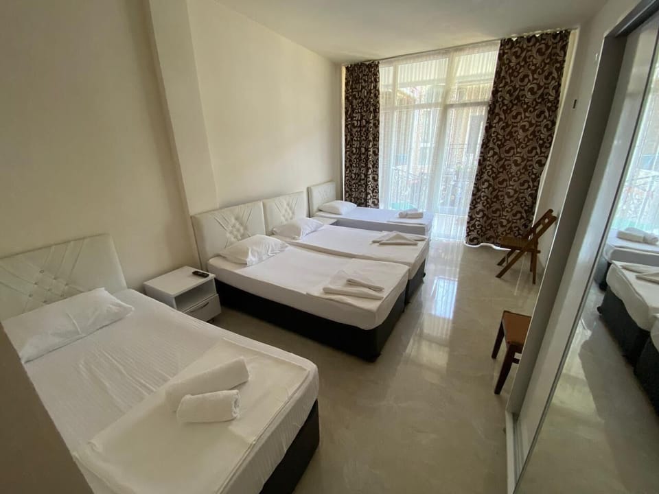 Classic Quadruple Room | Blackout drapes, iron/ironing board, travel crib, free WiFi