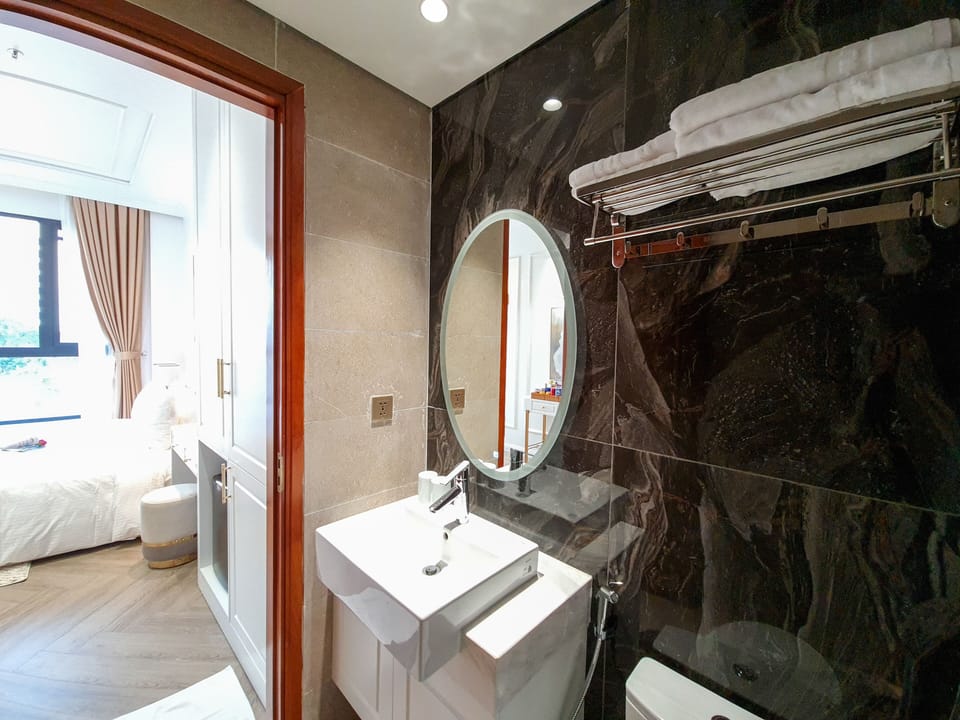 Deep soaking tub, hydromassage showerhead, designer toiletries