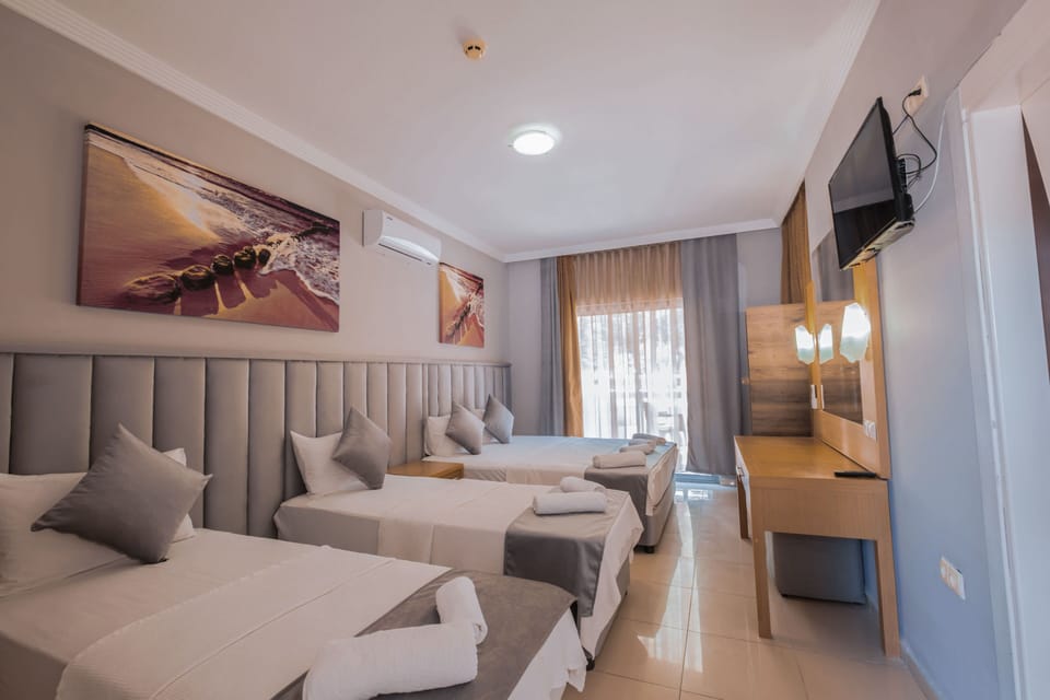 Deluxe Quadruple Room | Premium bedding, in-room safe, soundproofing, iron/ironing board