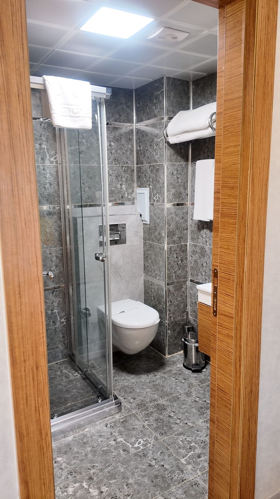 Shower, hair dryer, slippers, towels