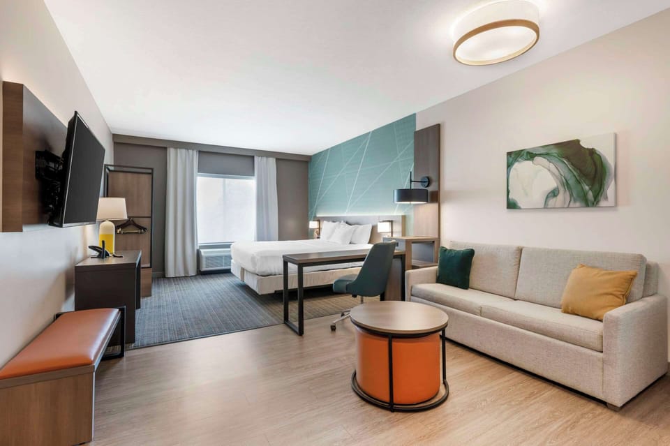 Premium bedding, desk, laptop workspace, blackout drapes