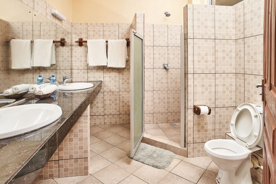 Superior Room | Bathroom | Shower, rainfall showerhead, slippers, towels